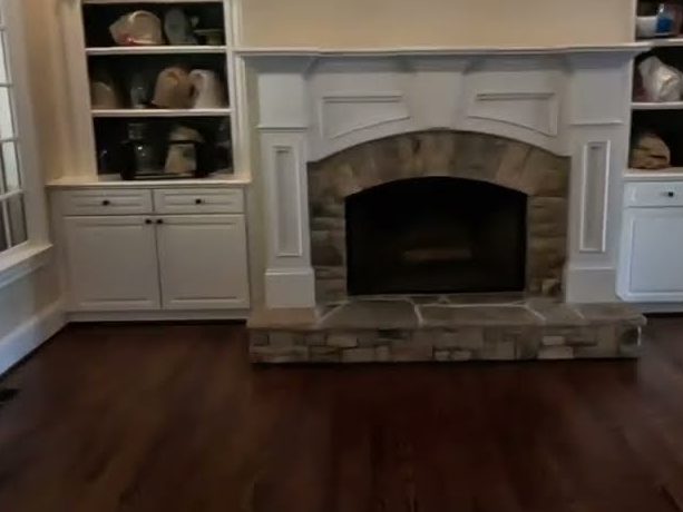 Medium Brown stained red oak floor in front of a stone fireplace, refinishing in Acworth, GA