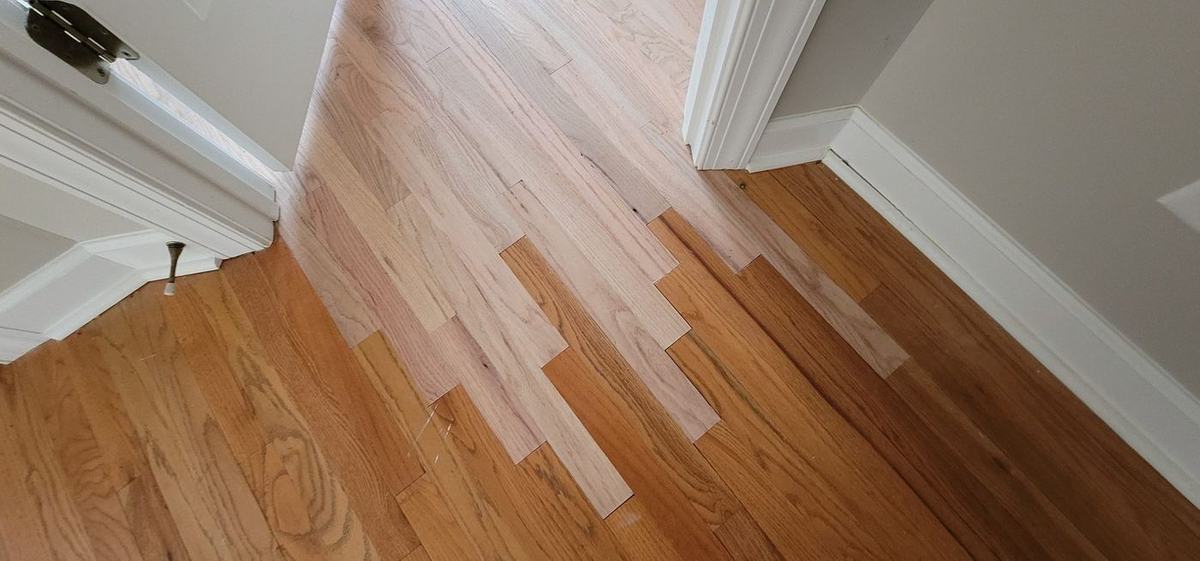 Hardwood floor patch and lacing repair service in progress in Atlanta