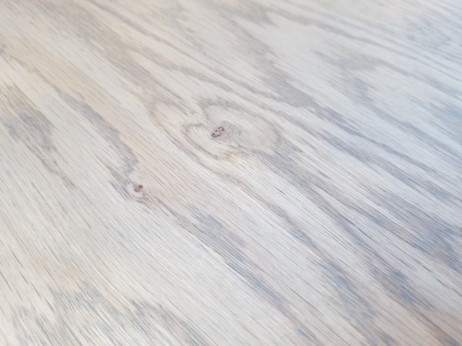 Gray hardwax oil finish sample on hardwood flooring