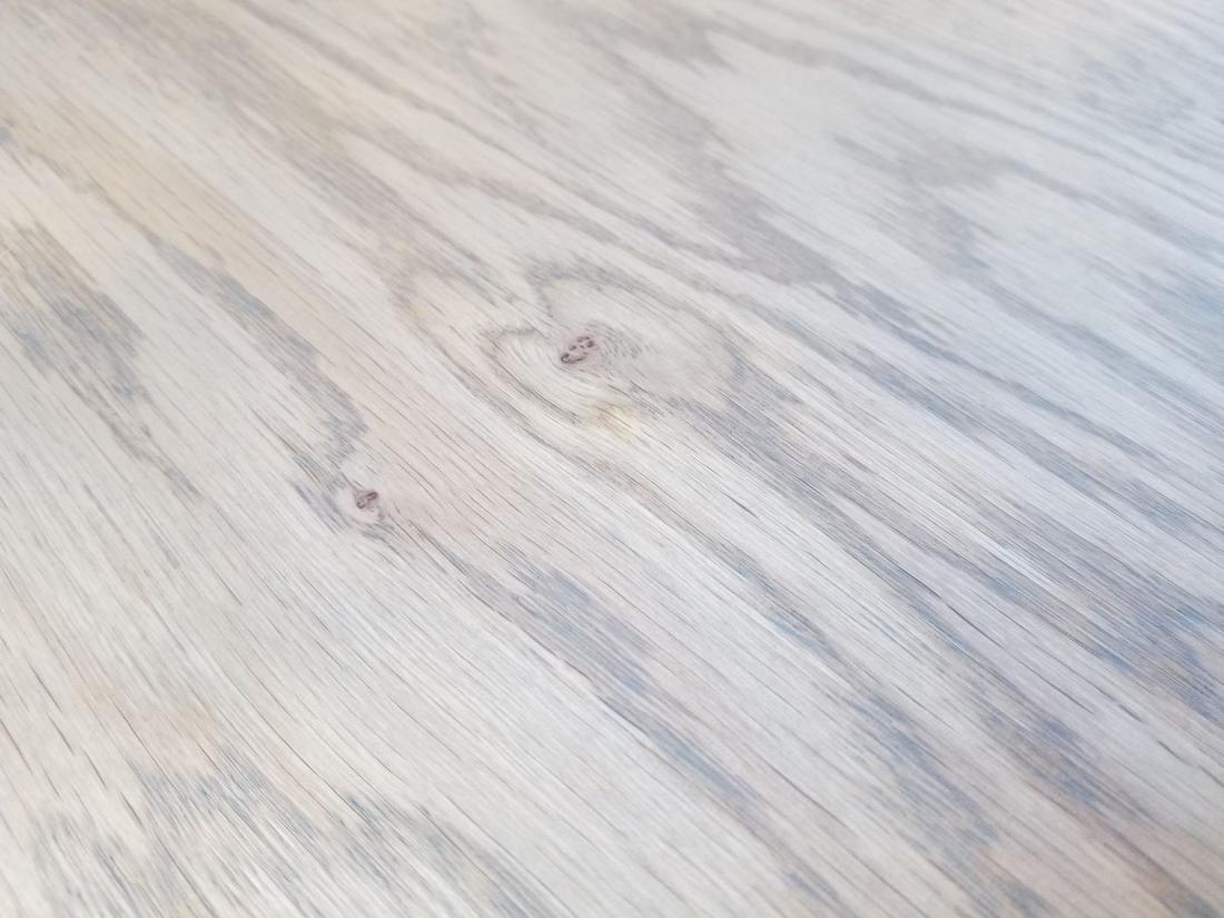 Gray hardwax oil finish sample on hardwood flooring