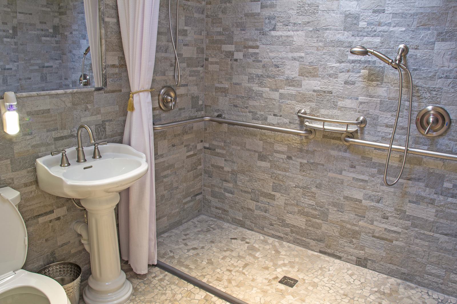 Curbless tile walk-in shower with grab bars, bathroom remodel by The Hardwood Guys