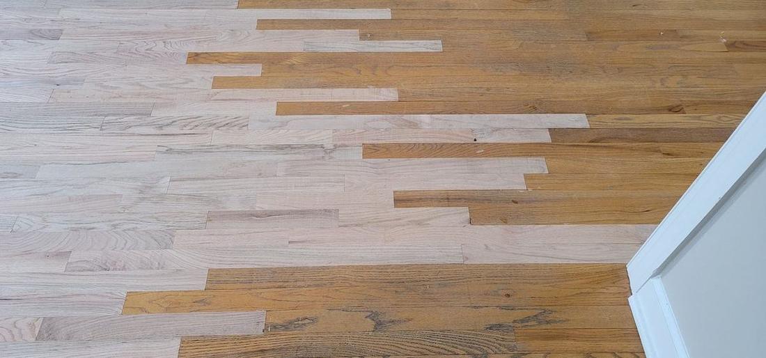 Wide-plank hardwood floor repair in progress in an Atlanta, Georgia home by The Hardwood Guys