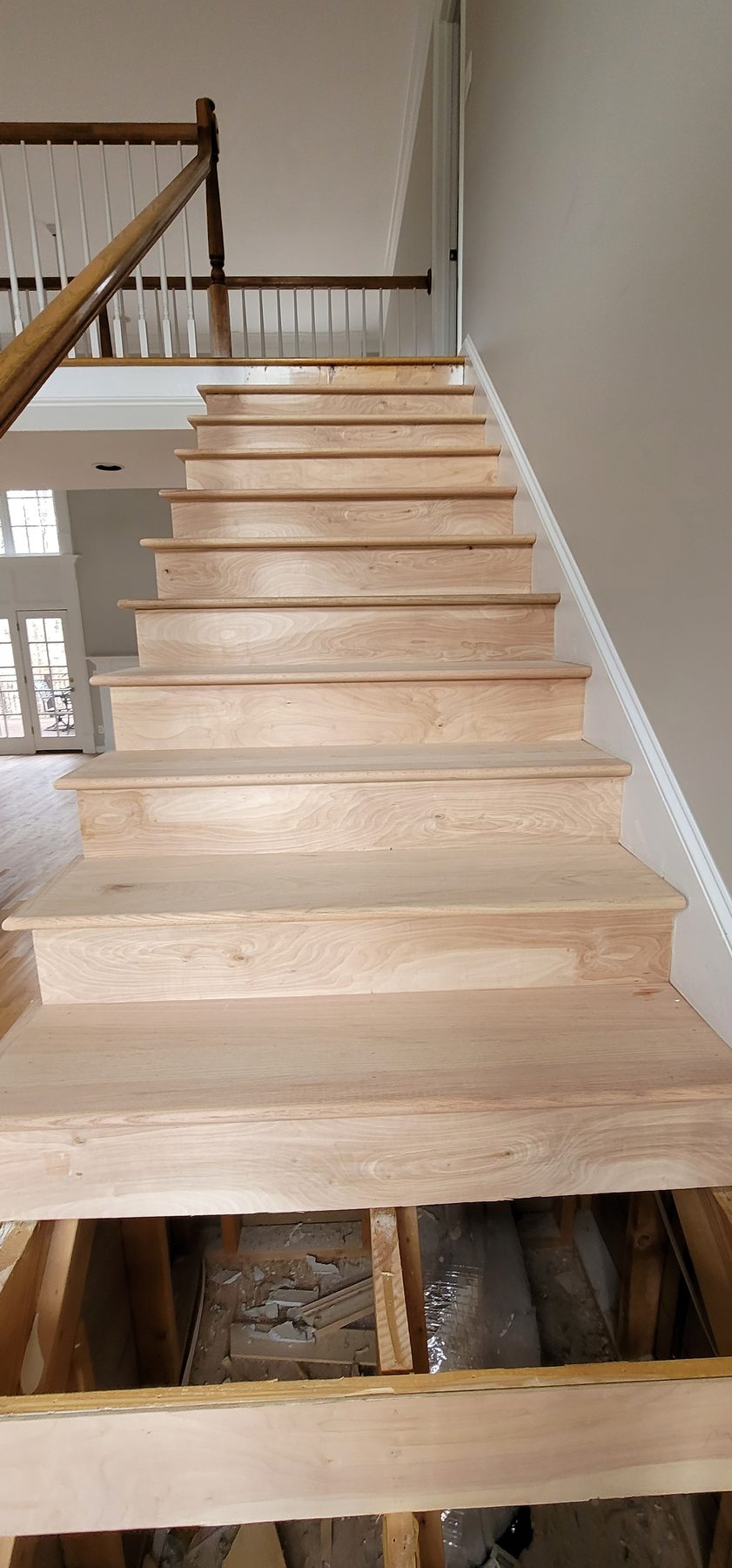 New stair treads scribed and fitted during a hardwood stair repair