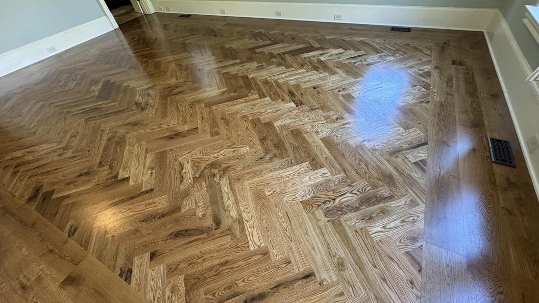 Herringbone hardwood flooring detail in an Alpharetta, GA home