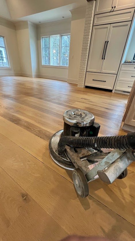Floor sanding machine mid-refinish in a Woodstock, GA area kitchen