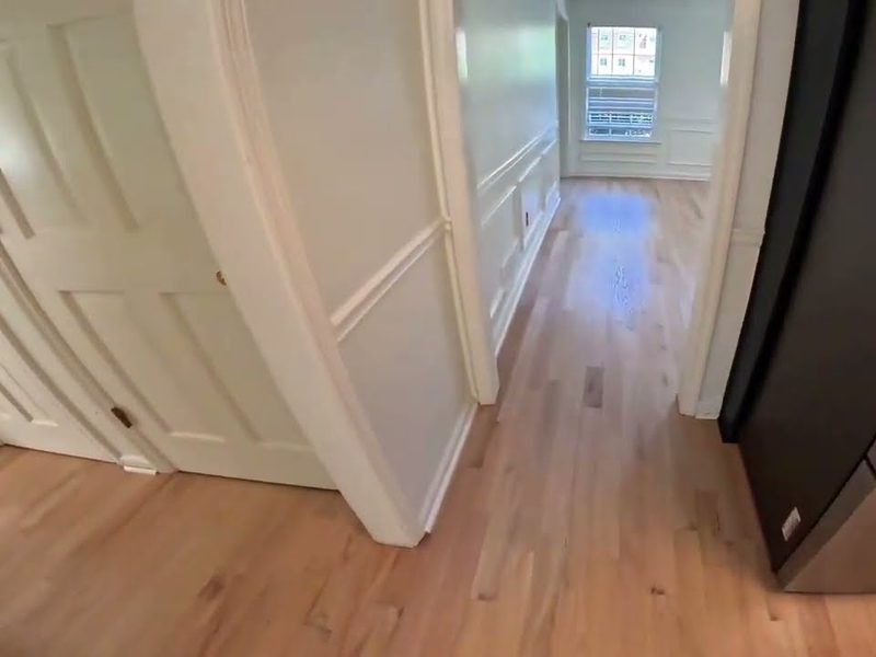 Light oak floor running down a hallway during refinishing in Marietta, GA