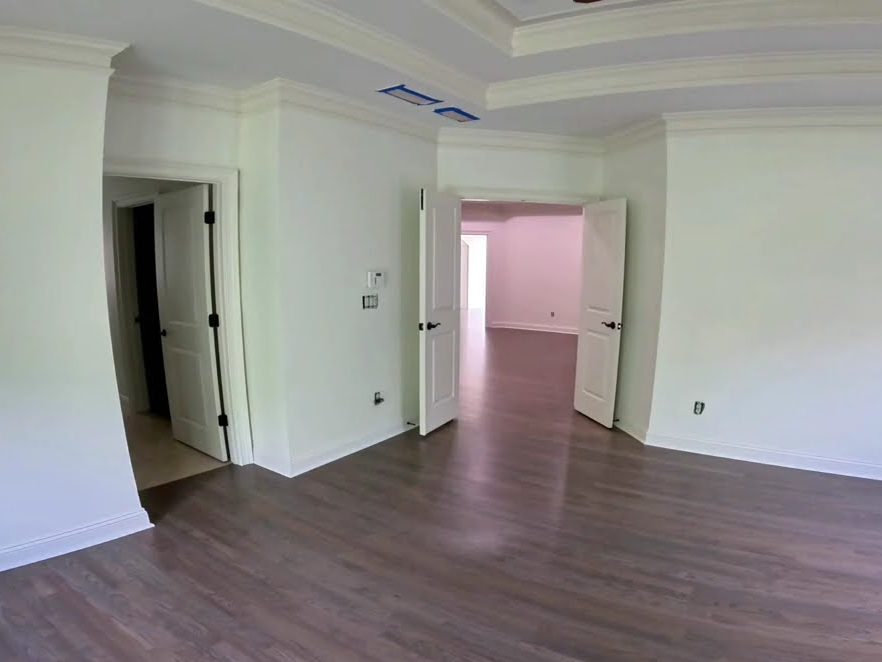 Classic Gray stained red oak floor in a room with double doors and a tray ceiling, refinishing in Roswell, GA