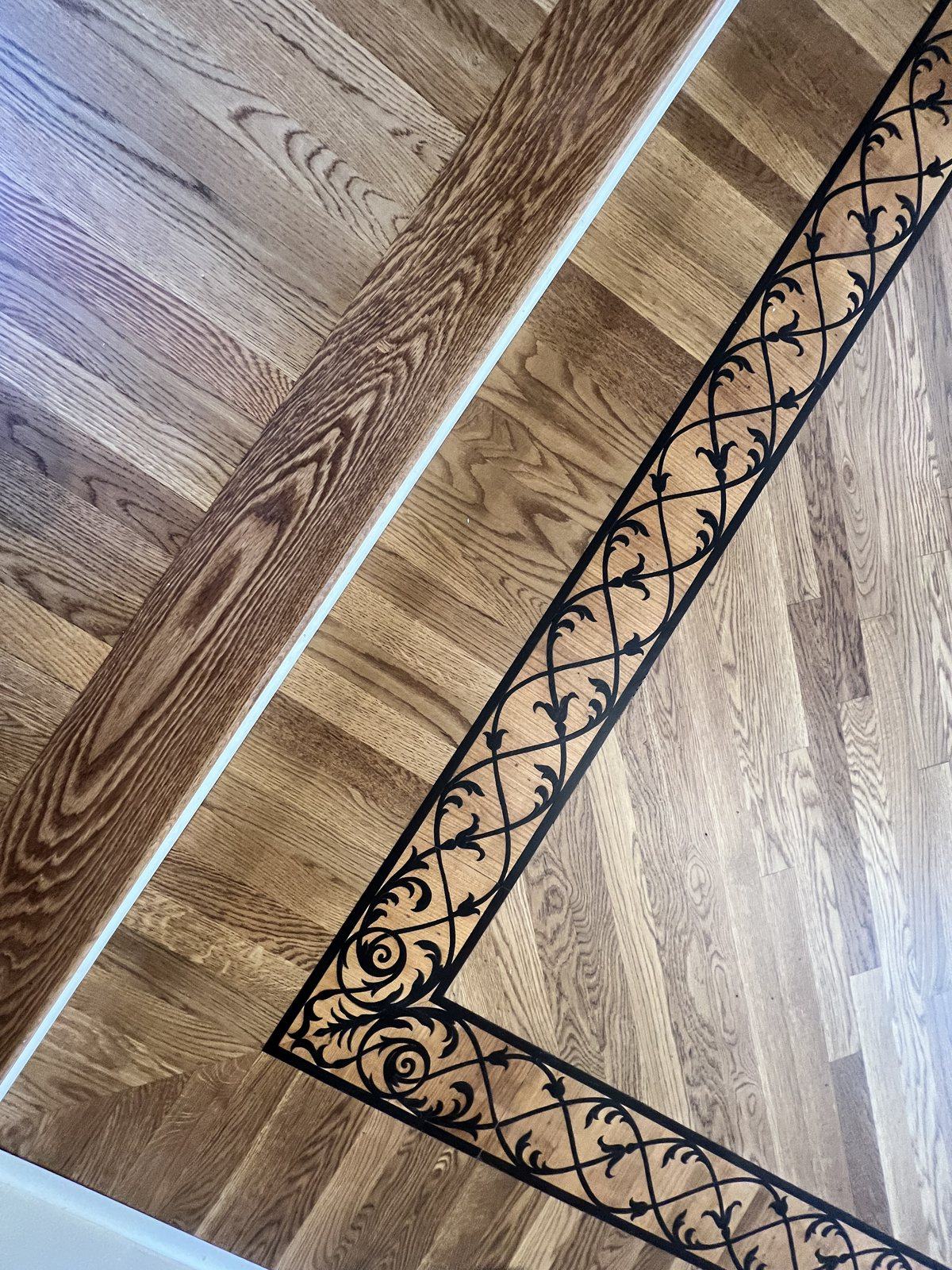 Corner detail of a decorative inlay border in a red oak hardwood floor, Golden Oak stain with matte finish