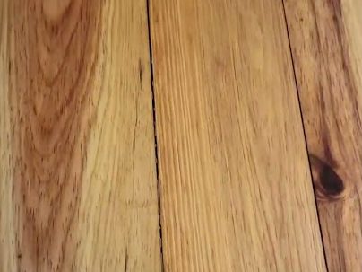 Close-up of pine floor boards with a knot, refinishing job in Woodstock, GA